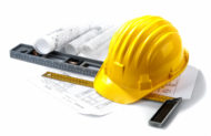 isolated hard hat with blueprints and rulers on white